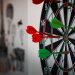 Close-up of a dartboard with multiple darts hitting the target, emphasizing precision and focus.