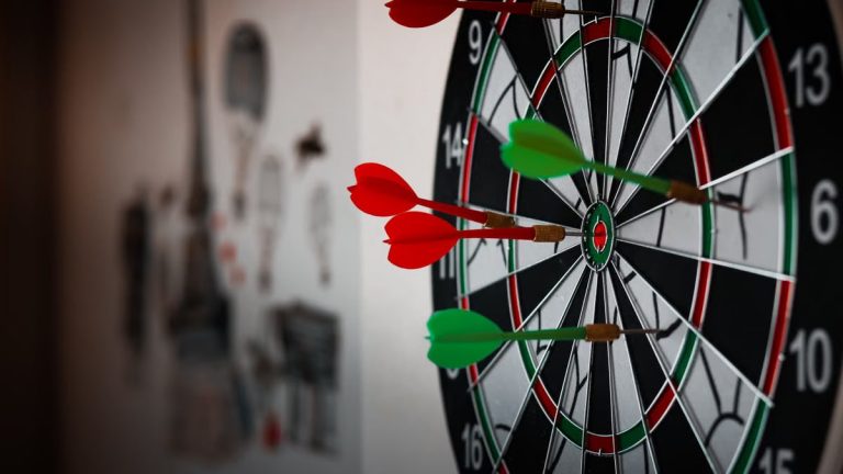 Close-up of a dartboard with multiple darts hitting the target, emphasizing precision and focus.